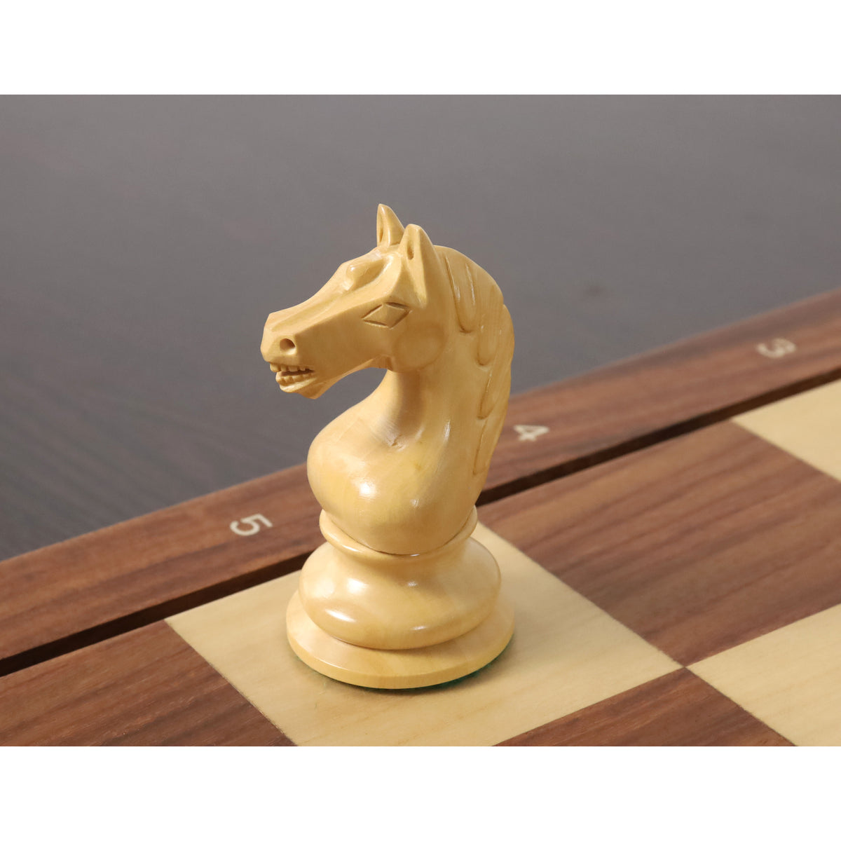 Detailed close-up of a hand-carved boxwood knight from the 1933 Soviet Botvinnik Flohr set.