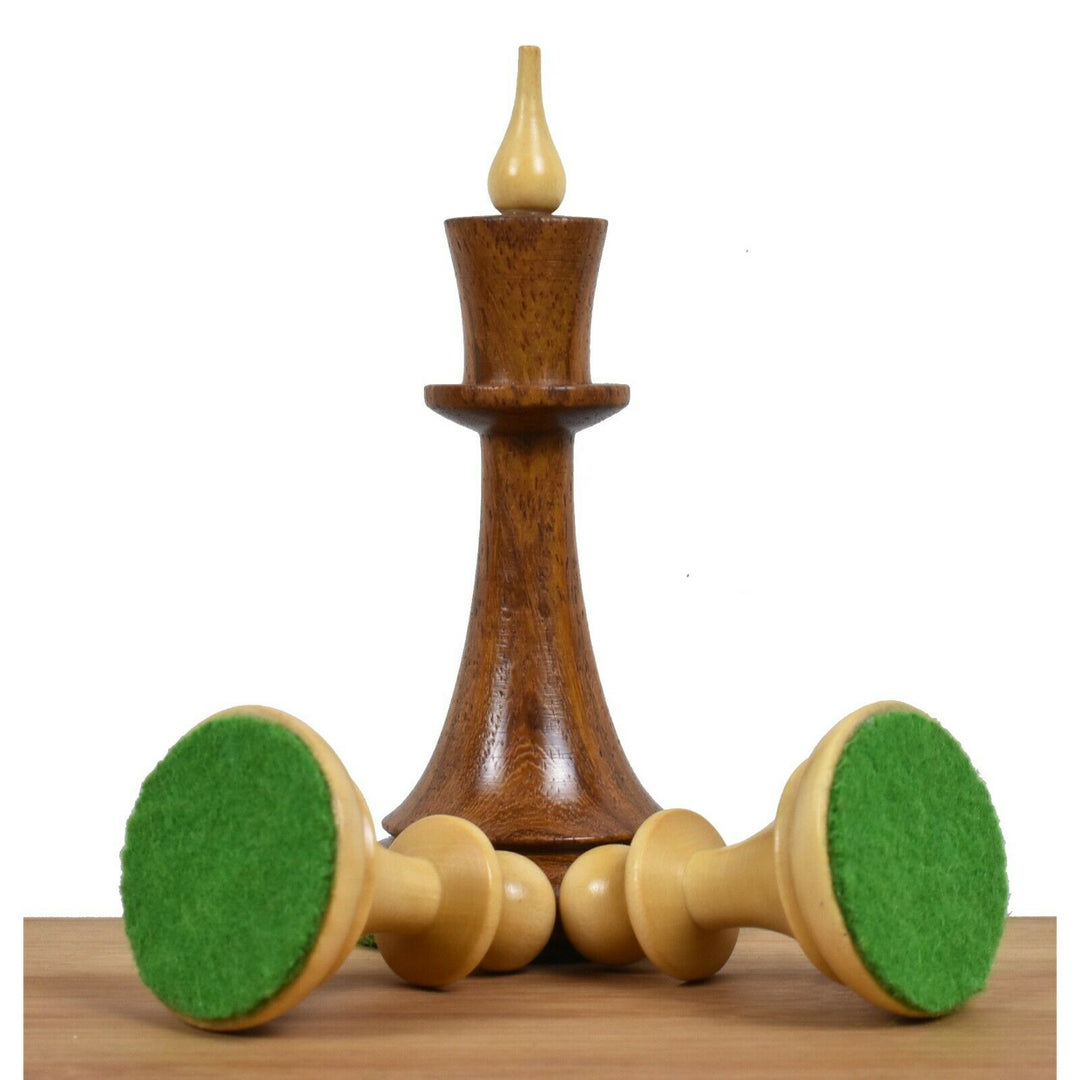 Golden rosewood king and boxwood pawns showing the protective green felted bases of the Latvian set.