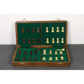 Internal green felted storage compartments for secure rosewood and maple chess pieces.