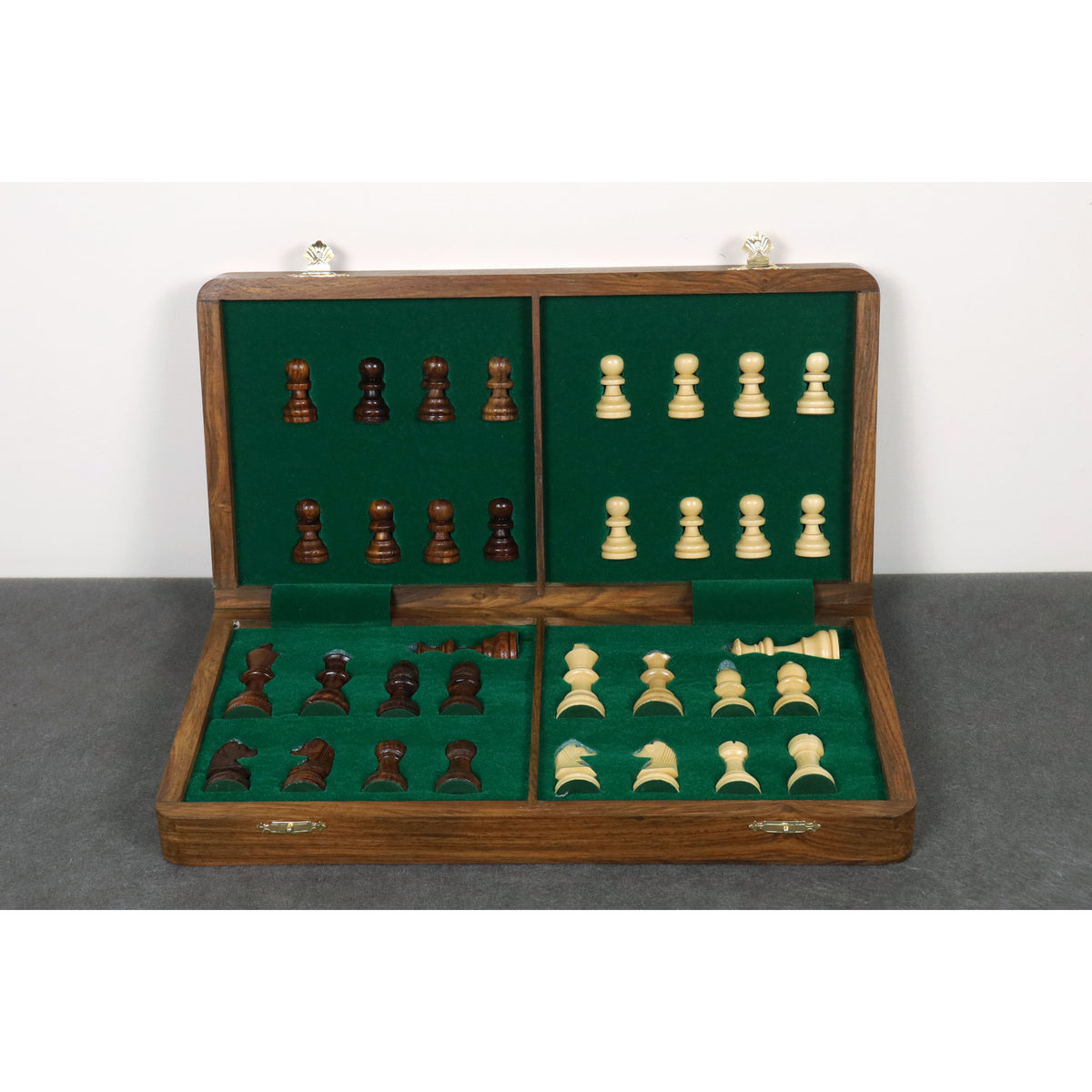 Internal green felted storage compartments for secure rosewood and maple chess pieces.