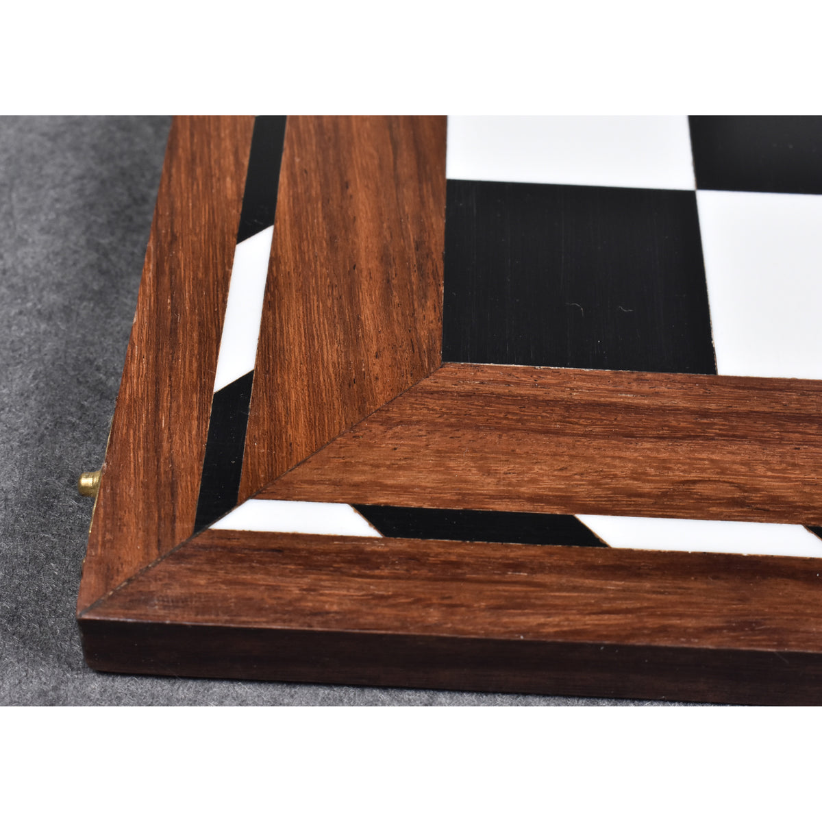 Detail shot of the precise wood inlay and acrylic ivory finish on a library series folding chess board.